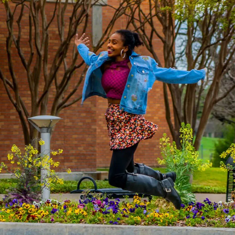 A student jumps through the air at the Richland campus