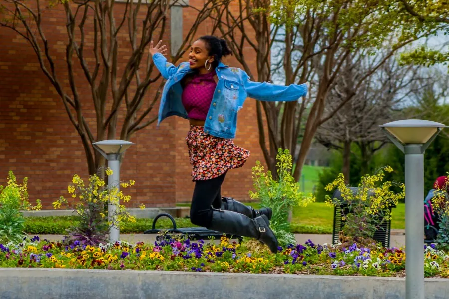 A student jumps through the air at the Richland campus