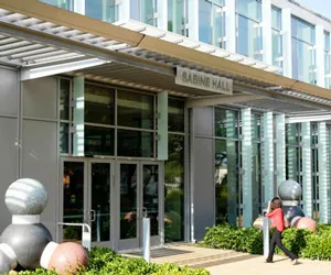 A student walks towards the doors of Sabine Hall at Richland Campus