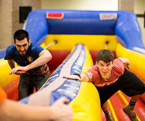 Students race each other in a large inflatable game at Eastfield