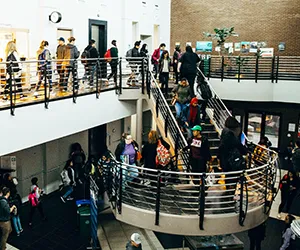 Students walk to class up and down a stairwell at North Lake