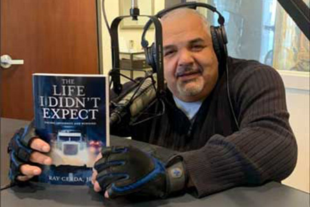 Ray Cerda in a radio studio wearing headphones.