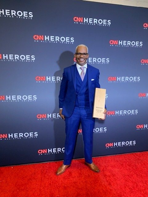 Richard Miles posing on red carpet at CNN Heroes Awards.