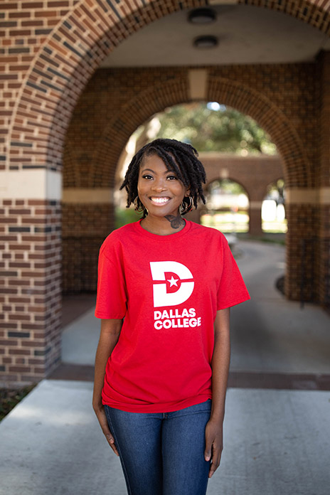 Karrington Bennett standing in archway on campus.