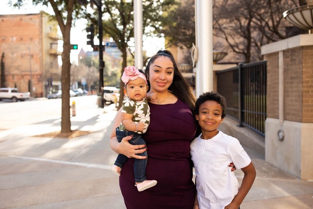Senquae Cox standing outside El Centro Campus with her two children.