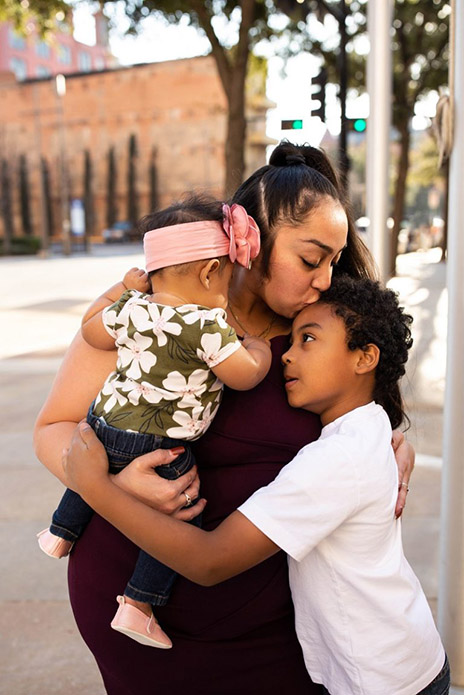 Senquae Cox embracing her children outside El Centro Campus.