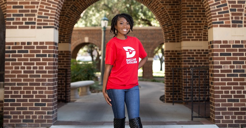 Karrington Bennett standing in archway on campus.