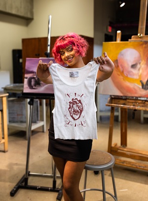 Arianna Castillo holding up a tank top.
