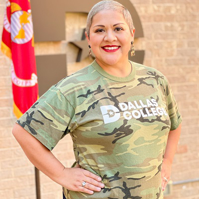 Melawn Dineen poses in front of Big D with US Marines flag in the background.