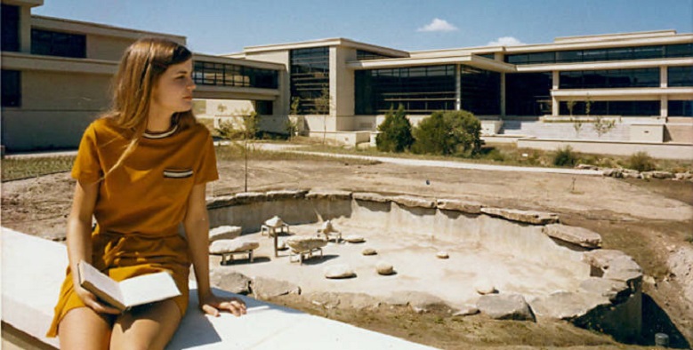 Vintage 1970s photo of student sitting in front of Mountain View Campus construction site.