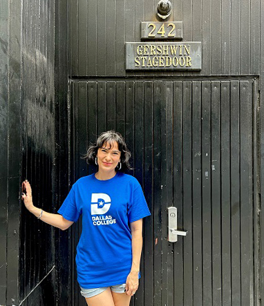 Alyssa Fox standing in front of Gershwin Theater stage door.