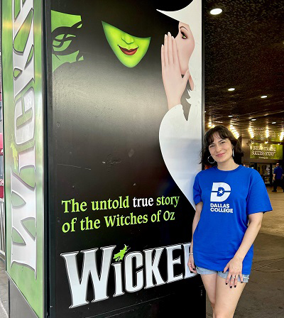 Alyssa Fox pointing to playbill.