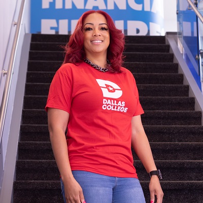 Krystal Hamilton standing in front of stairs wearing a Dallas College t-shirt.