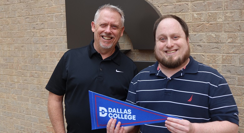 Ken and Joshua Kidd holding Dallas College pennant.