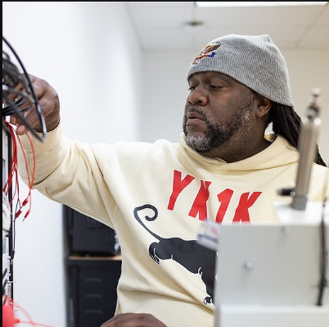 Marcus Russel adjusts some wires.