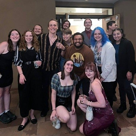 Stipe smiling at the camera with a group of others from the Santa Fe Opera.