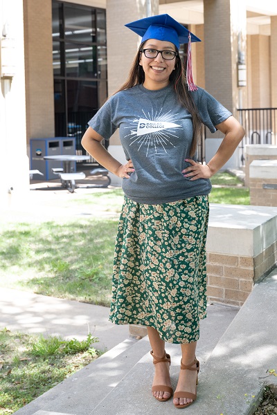 Daisy Donjuan standing outside a campus building.