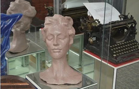 Stover's sculpture Stover created on display in Fannin Hall. Other items are in display, such as a typewriter.