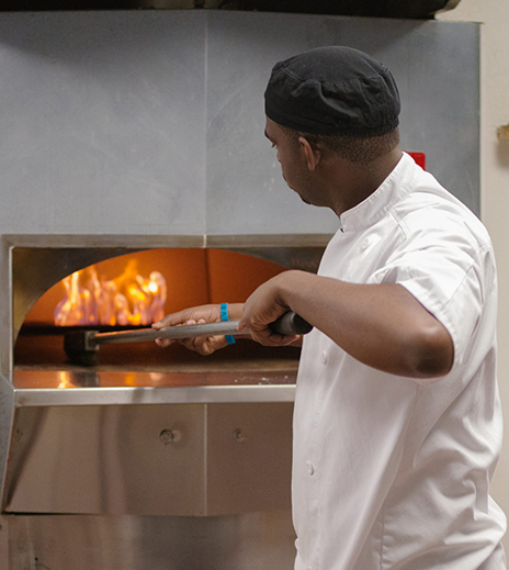 Tairan Lockett uses a semicircular pizza oven.