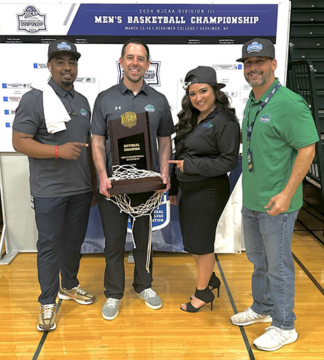 North Lake basketball coaches pose with trophy.