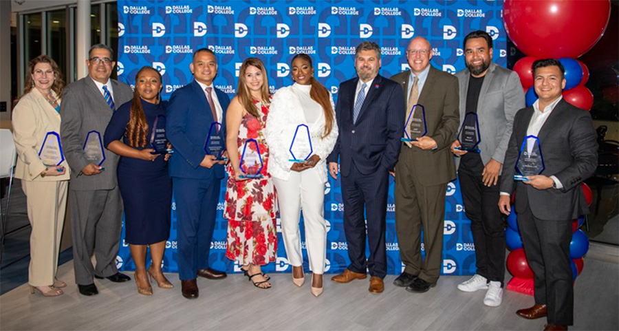 From left: Kathryn Martinez, Kevin Carbo Sr., Dr. Aeisha Taylor, Dr. Gerald Fernandez Napoles, Susan Laura Altamirano, Erykah Charione Agers, Chancellor Justin Lonon, Jeff Bickerstaff, Raul Herrera and JJ Ponce standing in front of a blue Dallas College background with a blue and red balloon arch.