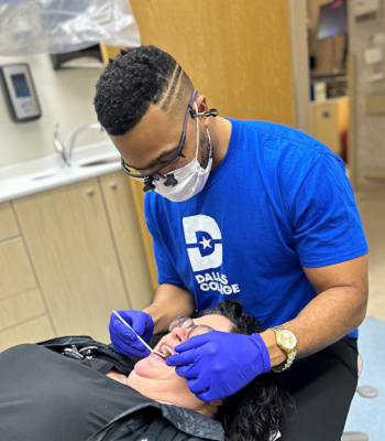 Dentist Davis examining a patient's tooth.