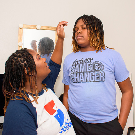 Jzantil with her son at her house.