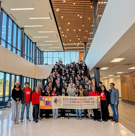 Group of Taiwanese visitors sitting on steps.