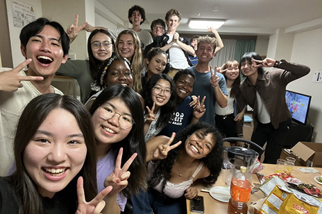 Group of smiling students in selfie.