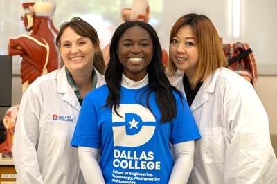 Student poses with faculty