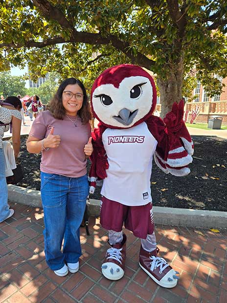 Yarumi Leon with TWU mascot.