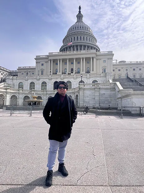 Amin standing in front of Capitol Hill