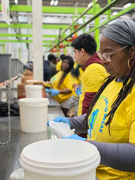 Students standing in a line helping at food bank.