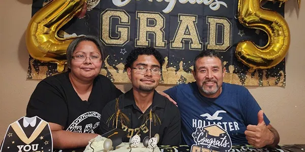 Alonso Jimenez is pictured with his parents at his graduation party after graduating from Dallas College.