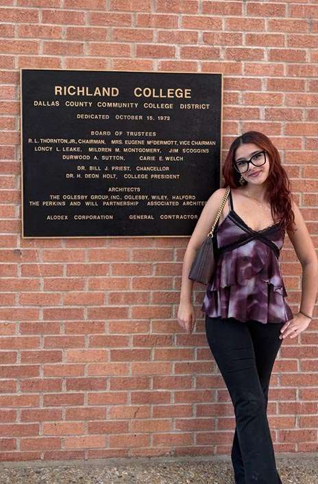 Amanda Ortiz standing next to Richland Campus founding sign.