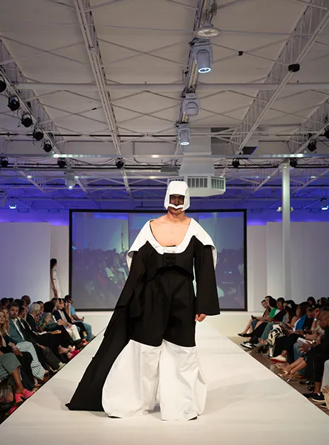 Male model wearing black and white garment.