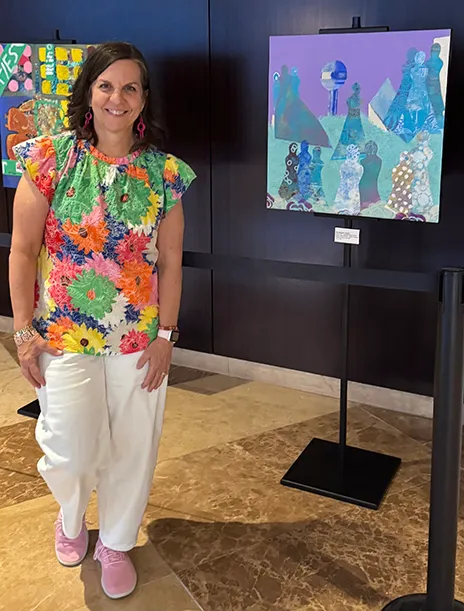 Branch-Lambert standing next to her painting in the Omni.