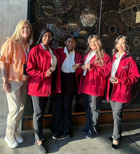 Four SkillsUSA students pose with a faculty member.