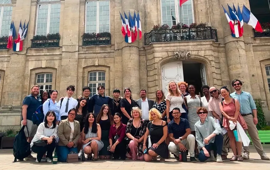 Large group in front of historic building in France.