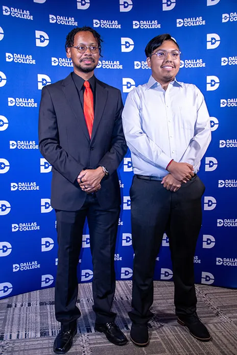 Noah Woodson and Javier Basilio pose in front of Dallas College backdrop.