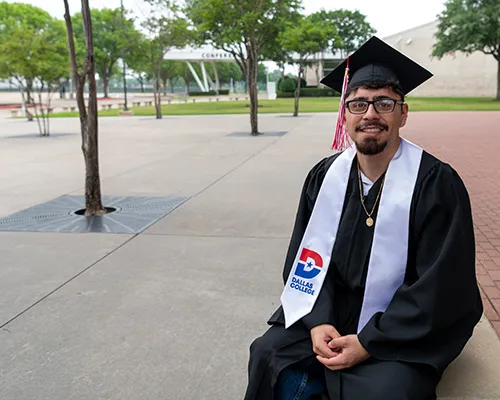 Leonardo Cortes is pictured outside in a cap and gown.