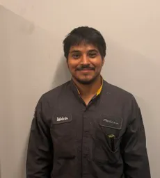 Melvin Ancelmo in mechanic uniform.