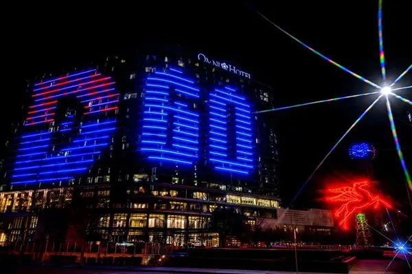 The Dallas College logo is displayed on the side of the Omni hotel in downtown Dallas