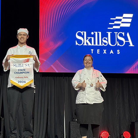 Rosemary Pate and another student standing on stage at Skills USA.