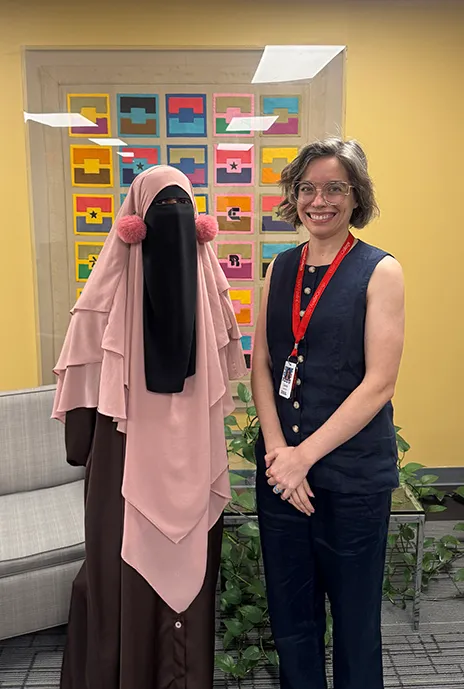 Student posing with her art teacher.