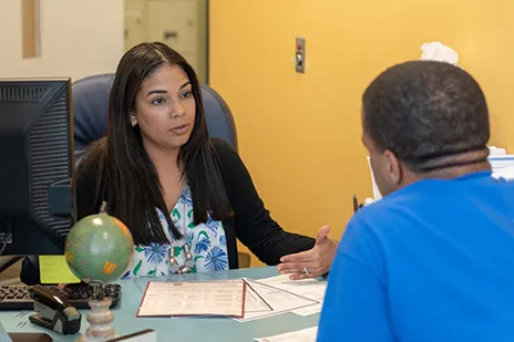 Student sitting across the desk from an advisor or counselor