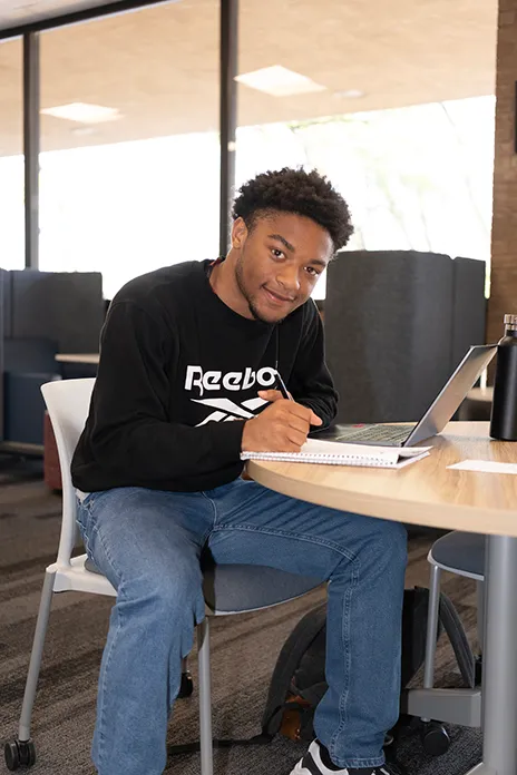 Student sitting at desk writing