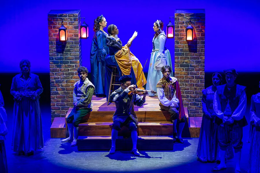 Ten theater students performing a play on stage.