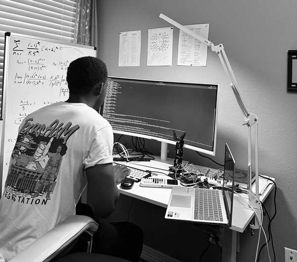 Moussa Mukendi is pictured sitting in front of a computer.
