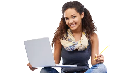 Student sitting down and smiling with a laptop and pencil